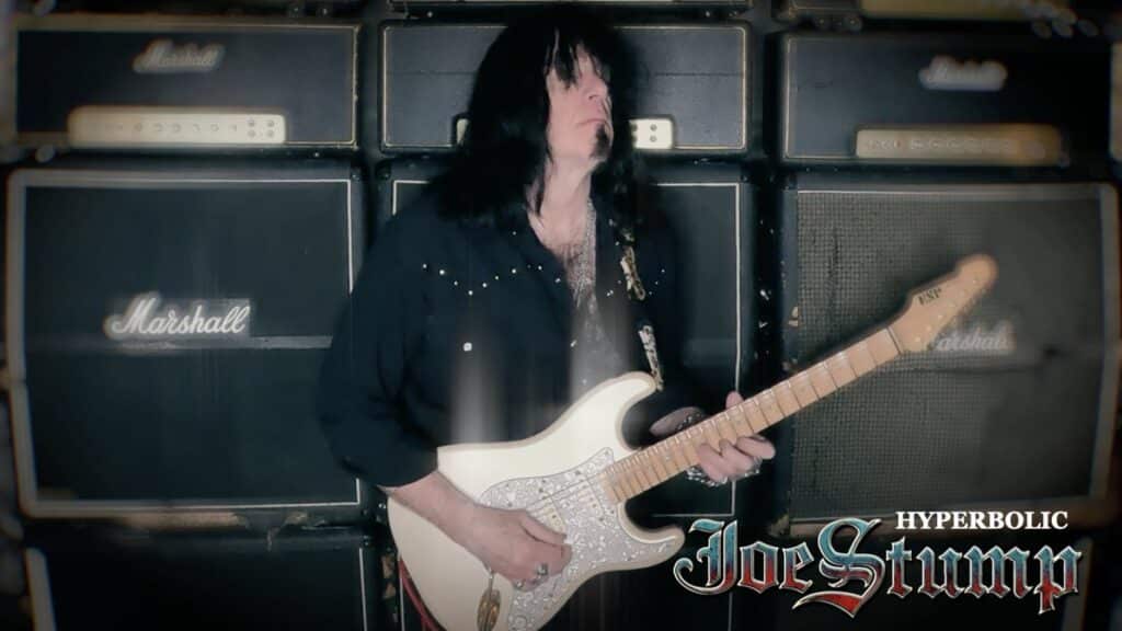 Joe Stump playing guitar in the Hyperbolic video