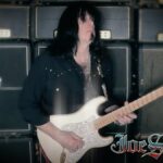 Joe Stump playing guitar in the Hyperbolic video