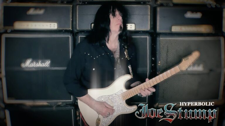 Joe Stump playing guitar in the Hyperbolic video