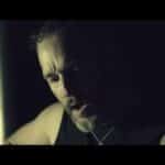 Andy Clarke of The Crawling playing acoustic guitar at night