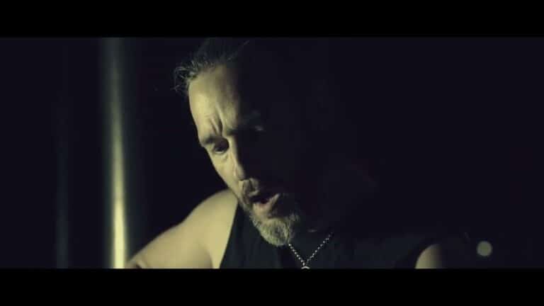 Andy Clarke of The Crawling playing acoustic guitar at night